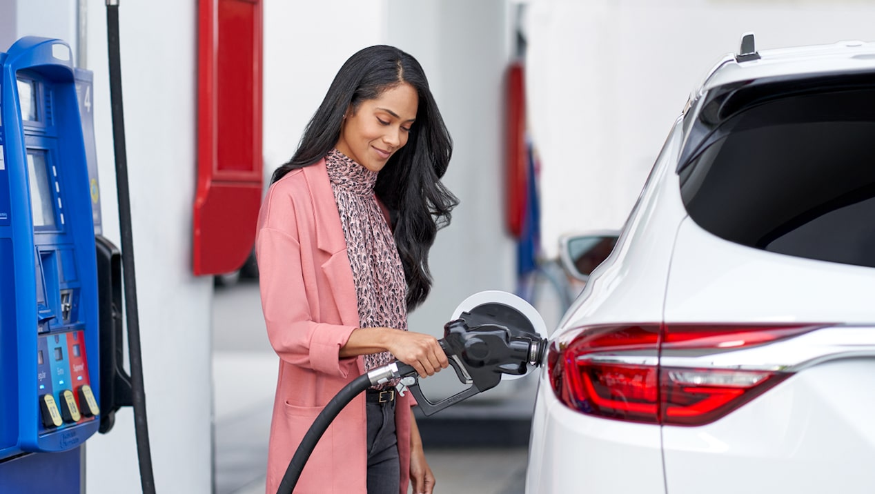 Woman fueling her Buick Enclave using her GM Business Card