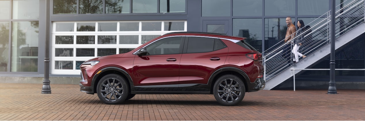 Side Profile Of The 2024 Buick Encore GX ST Parked Outside Glass Building