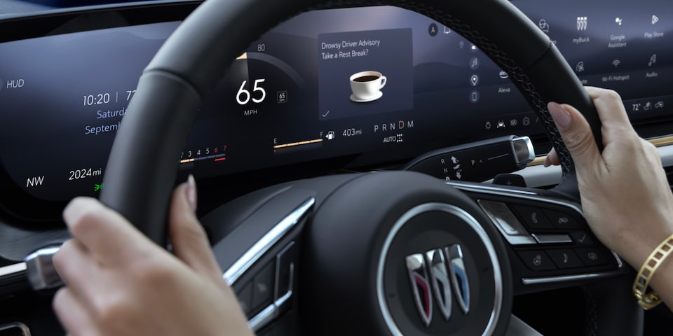 Close-up of a Person's Hands on the Steering Wheel of a 2024 Buick Envision Avenir