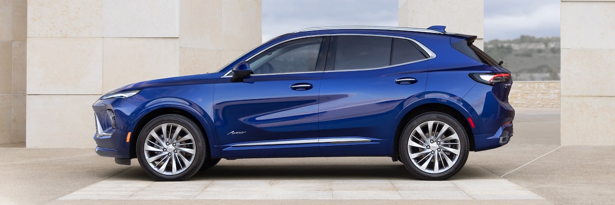 Side View of the 2024 Buick Envision Crossover Parked In Front of a Building