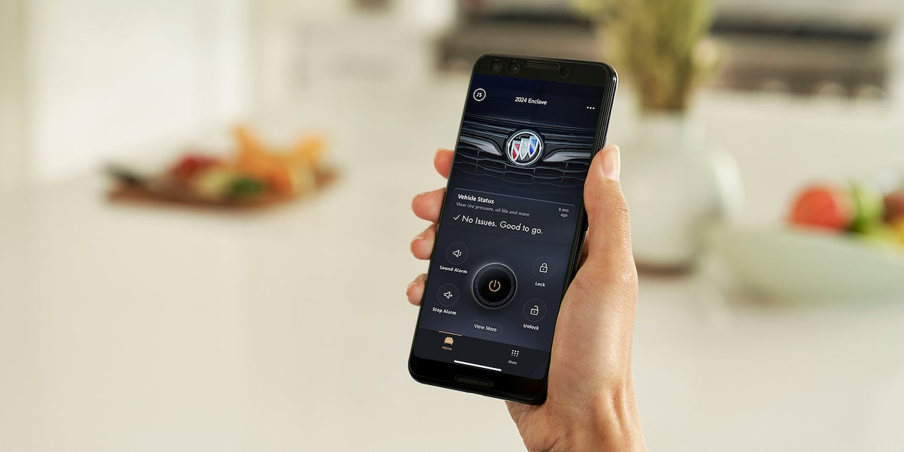 Person Holding a Smart Phone Displaying the MyBuick App Vehicle Status Update
