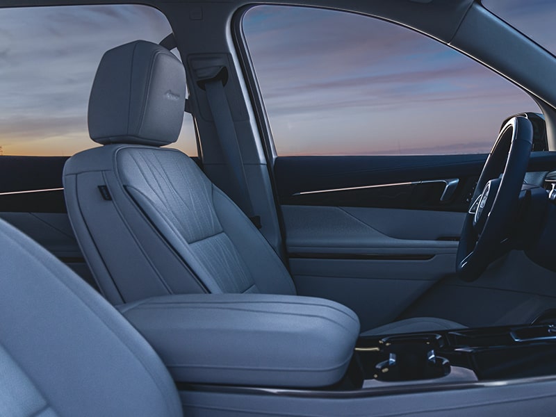 Side View of the Front Seats in a Buick 2025 Enclave under the Evening Sky