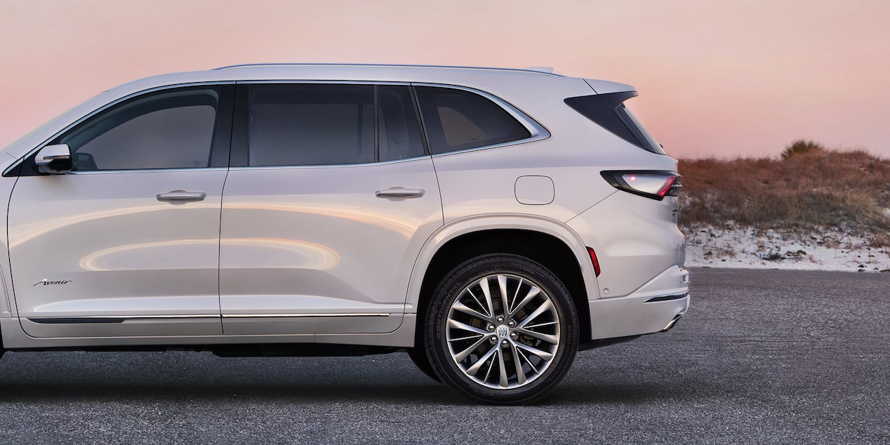 Side View of a 2025 White Buick Enclave Under an Evening Sky