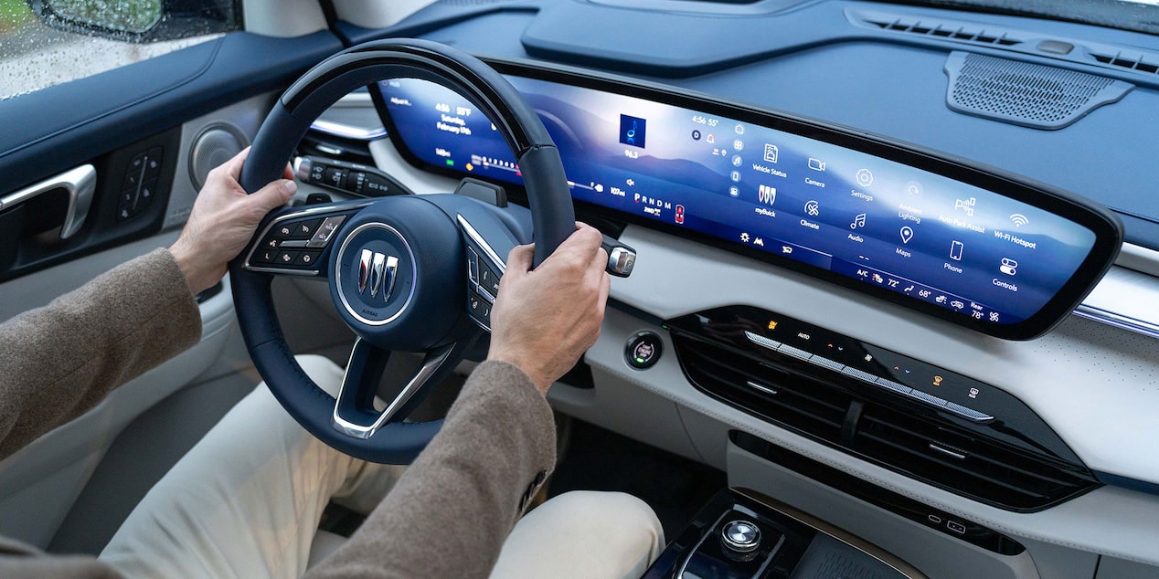 Birdseye View of a Driver Holding the Steering Wheel and Infotainment Screen in Use