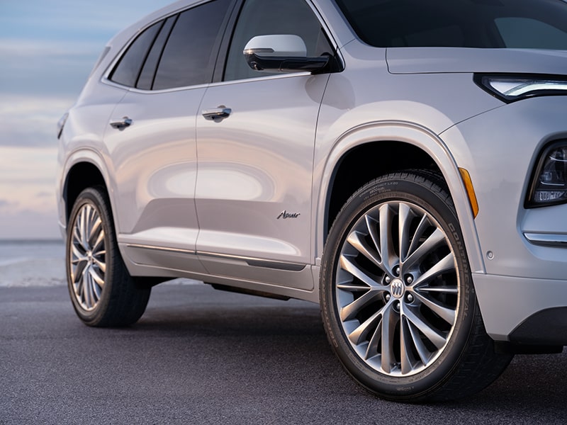 Low-Angle Front View of a White 2025 Buick Enclave Parked on the Road