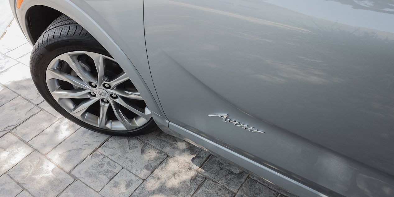 Close-up Driver Side View of a 2025 Buick Encore Avenir Tire and Model Logo