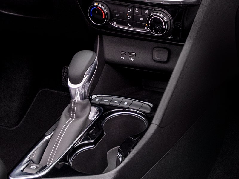 Close-up View of a 2025 Buick Encore GX Avenir Console's Shifter and Wireless Charging Port