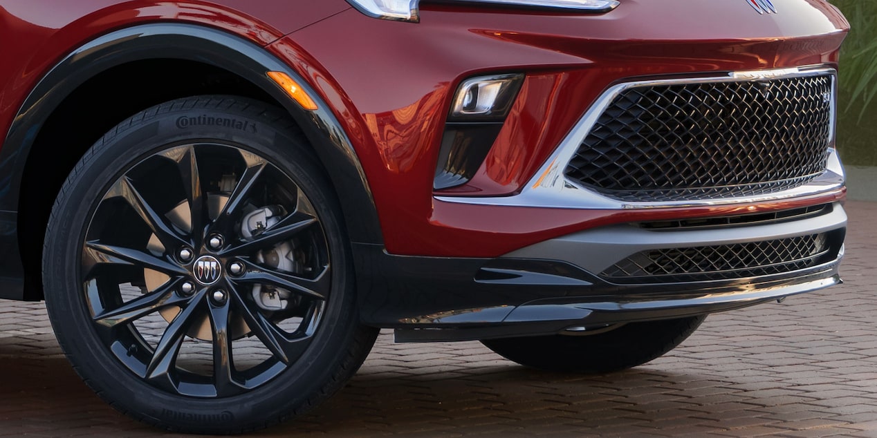 Close-up View of a Red 2025 Buick Encore GX ST Grille and Tire