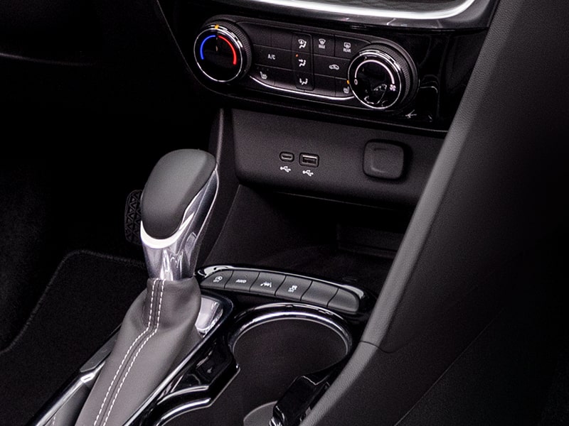 Close-up View of 2025 Buick Encore GX Console's Shifter and Wireless Charging Port