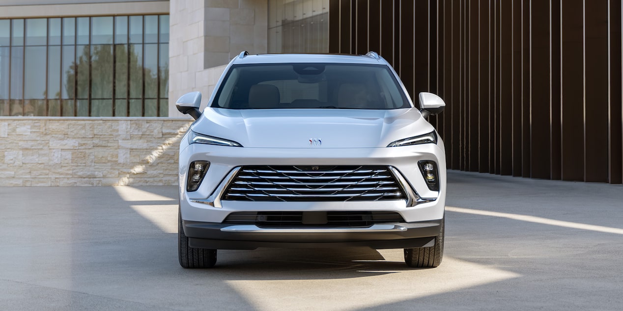 Wide Head-On View of a 2025 Buick Envision Small SUV Parked Near a Building