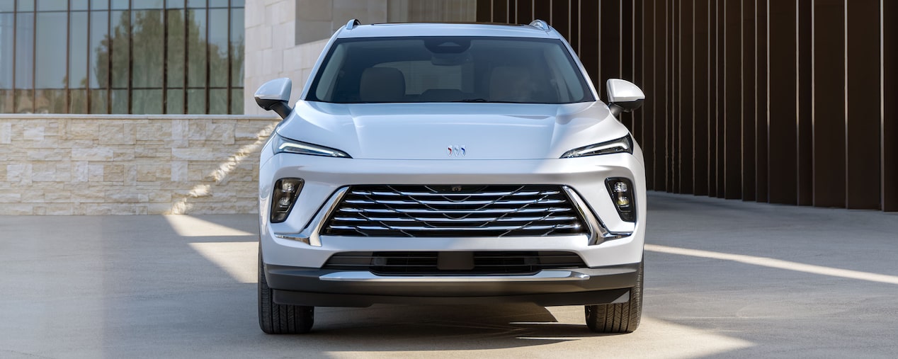 Head-On View of a 2025 Buick Envision 5 Passenger SUV Parked in Front of a Building