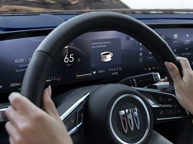 Close-up View of a Person's Hands on a Steering Wheel Showing the Digital Dashboard in a 2025 Buick Envision Crossover