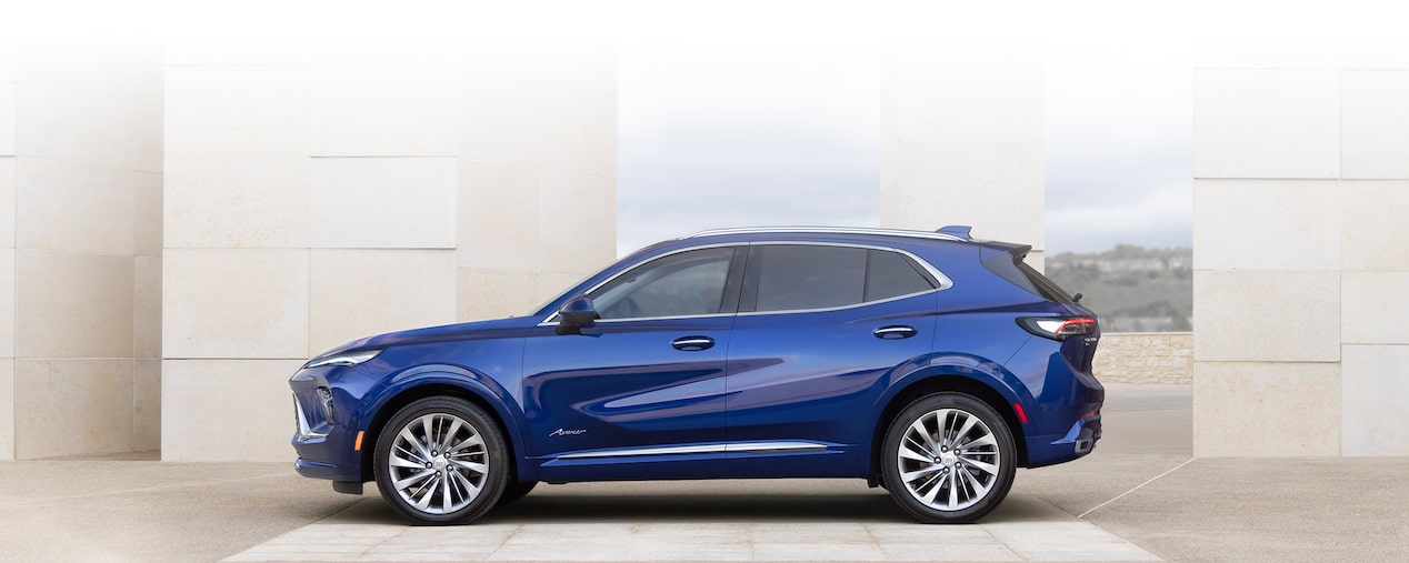 Wide Front Three-Quarters View of a 2025 Buick Envision Compact SUV Parked in Front of a Building