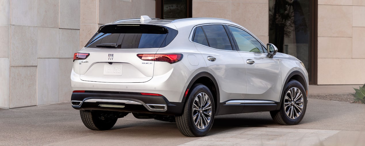 Rear Three-Quarters View of a 2025 Buick Envision Small SUV Parked Near a Building