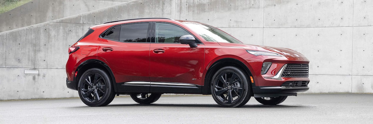 Wide Side View of a 2025 Buick Envision ST Sporty Crossover in an Empty Parking Lot