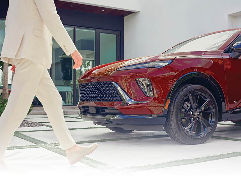 View of the Front of a 2025 Buick Envision ST Sporty Compact SUV with a Person Walking Nearby