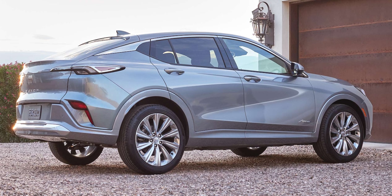 Rear View Passenger Side of the 2025 Buick Envista Avenir Compact SUV Parked in a Gravel Driveway