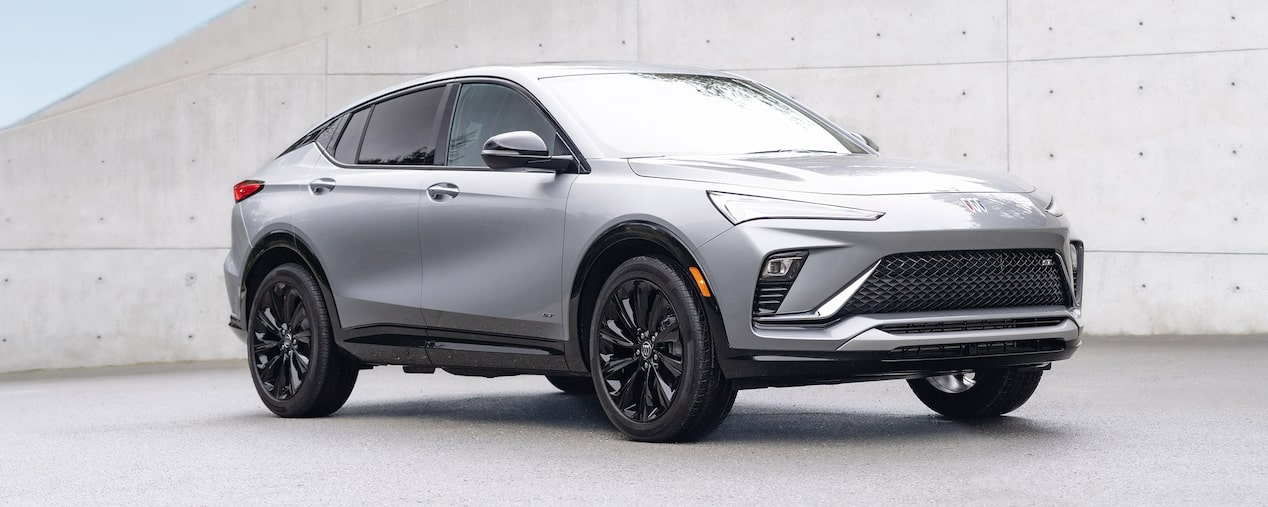 Front Passenger Side View of the 2025 Buick Envista Luxury Crossover Parked by a Concrete Wall