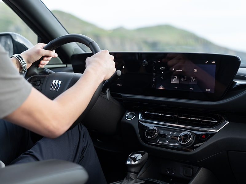 A Blurry Passenger View of a Man Driving the 2025 Buick Envsita