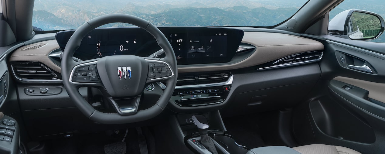 Driver Seat View of the 2025 Buick Envista Infotainment System and Dashboard Outlooking the Mountains