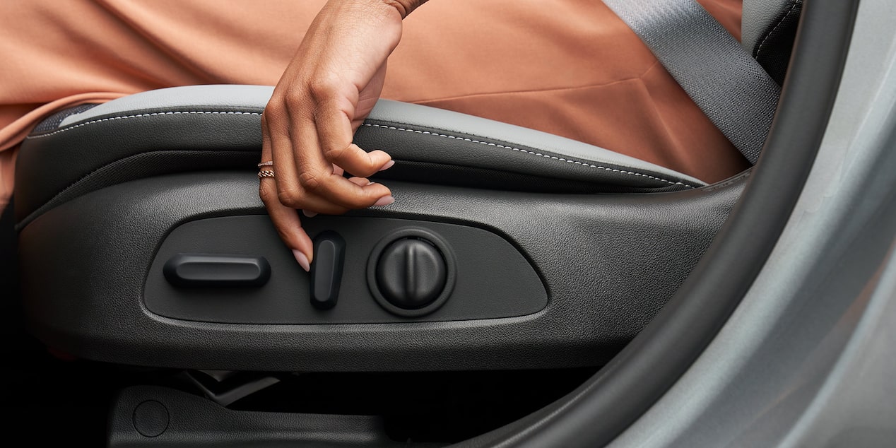 Woman in the Seat of the 2025 Buick Envista Using the Side Seat Controls