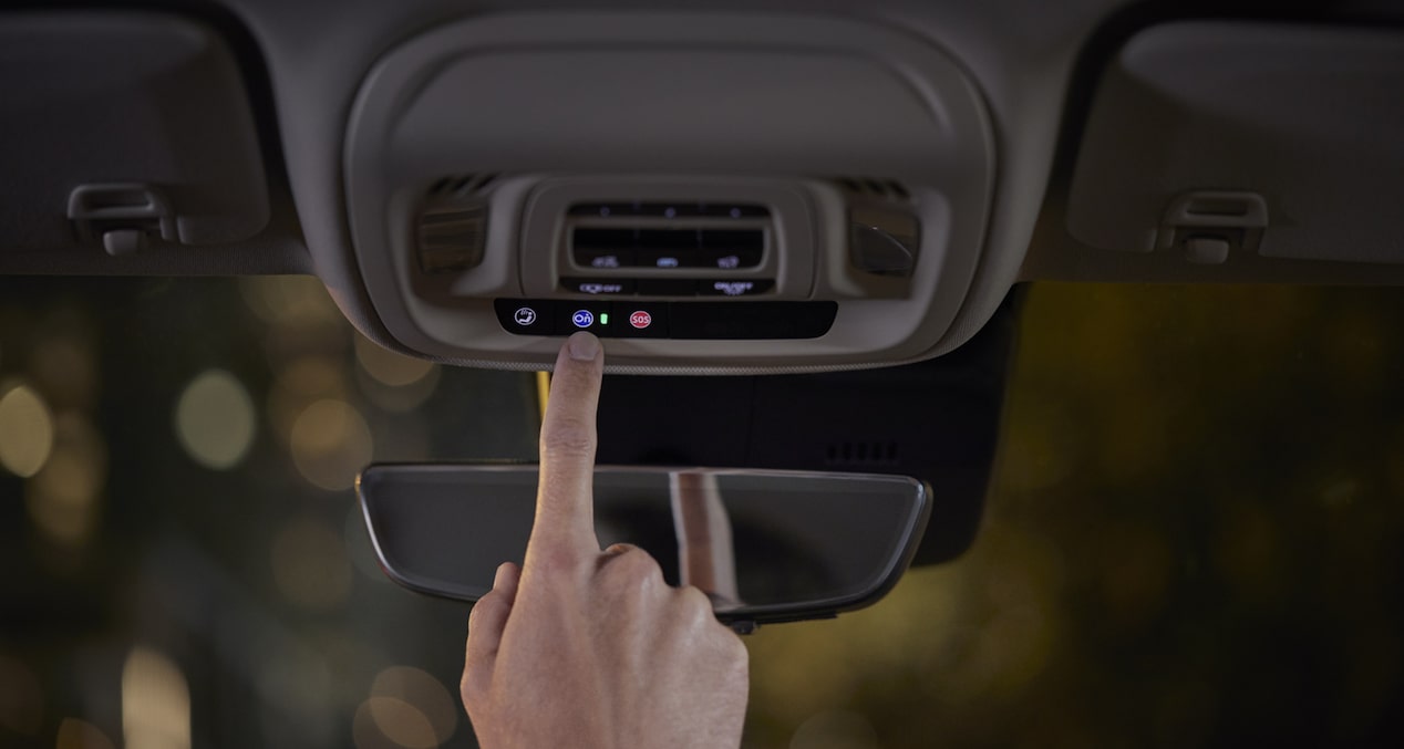 A Person Clicking the Buick OnStar Connectivity Button