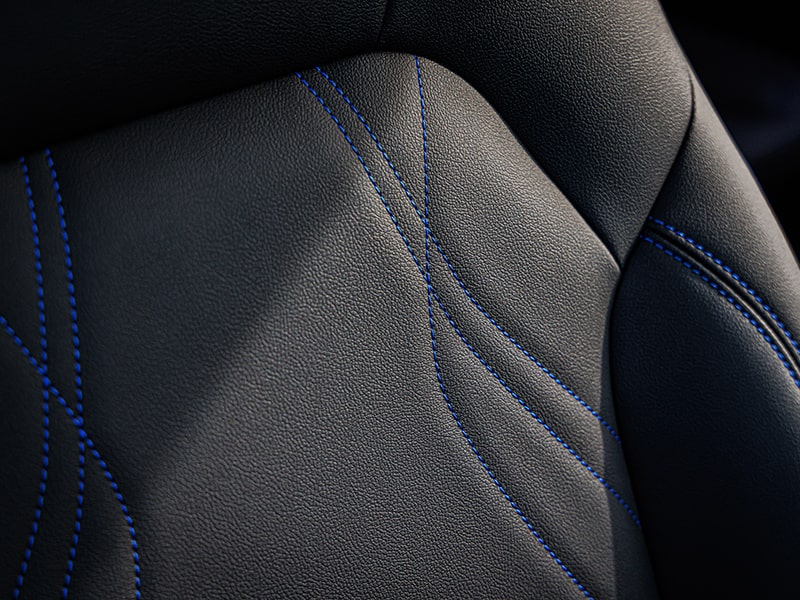 Close-Up View of a Black Leather Seat with Blue Stitching on a Buick Seat