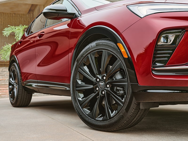 Close Up View of a Buick's Tire and Wheel Parked in Front of a House