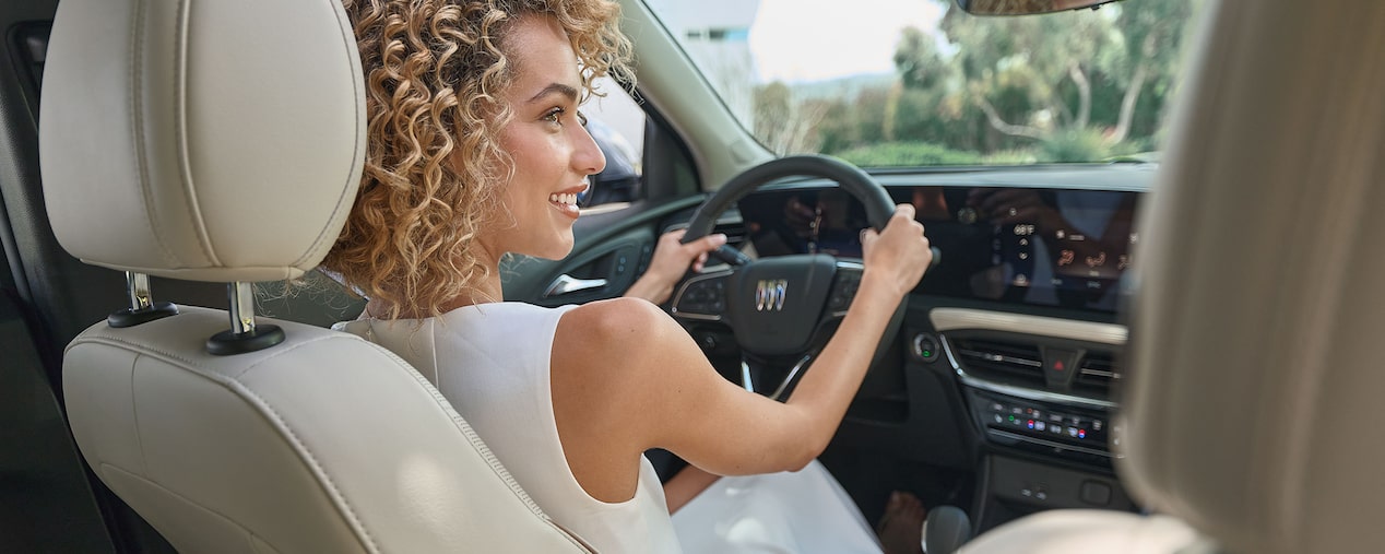 Back Seat View of a Woman Smiling in Buick Driver Seat