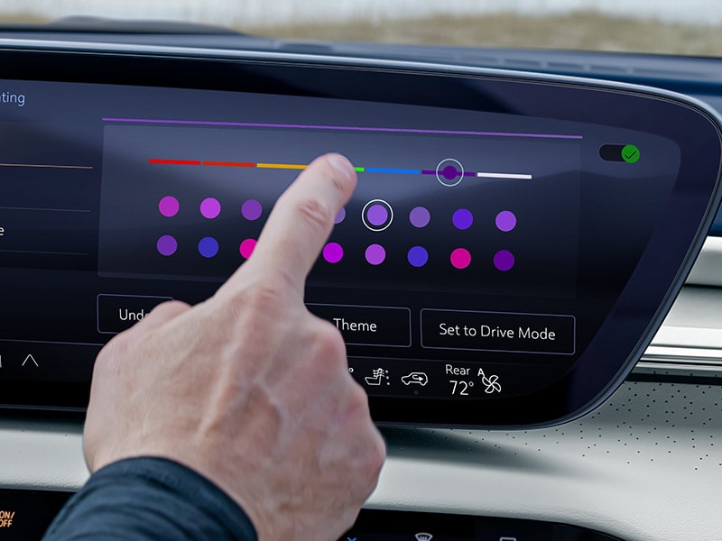 A Finger Pointing at the Infotainment Screen in a 2025 Buick Enclave ST Sport SUV