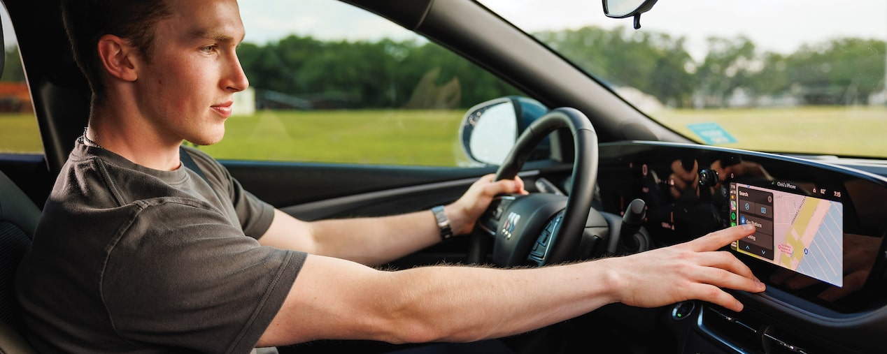 A Man Using the Infotainment System of a Buick Envista