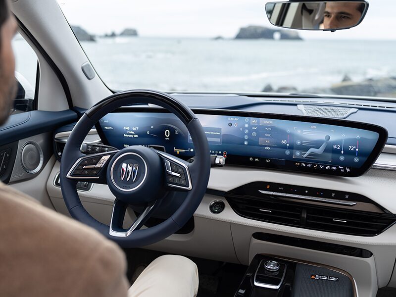 A Man Sitting in the Driver Seat of a Buick Enclave