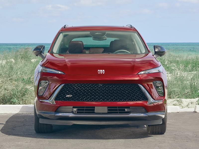 Front View of a Red Envision Sport Touring Parked in Front of a Body of Water