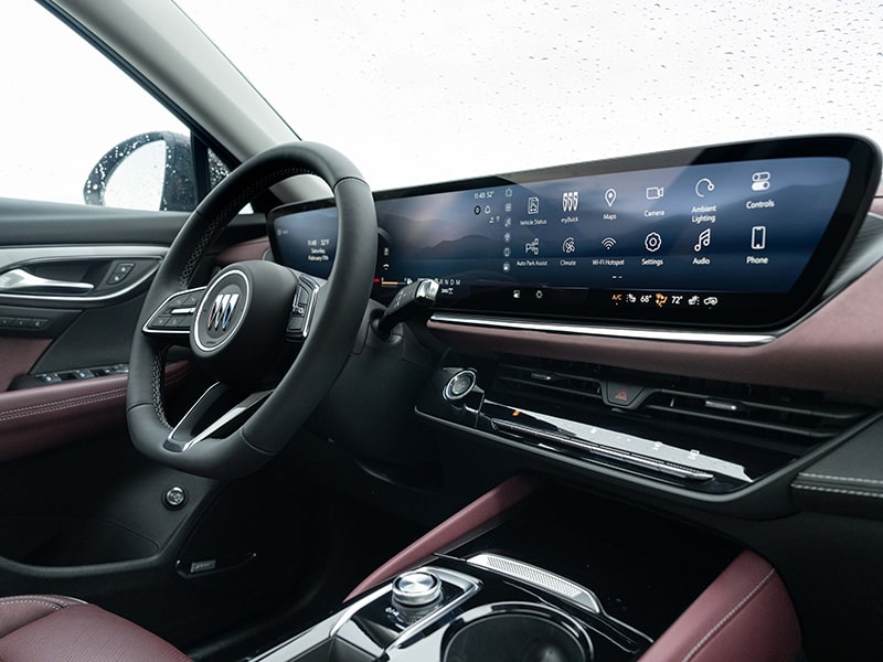 Close-up Interior View of the Buick Envision Sport Touring SUV’s Infotainment Screen, and Steering Wheel