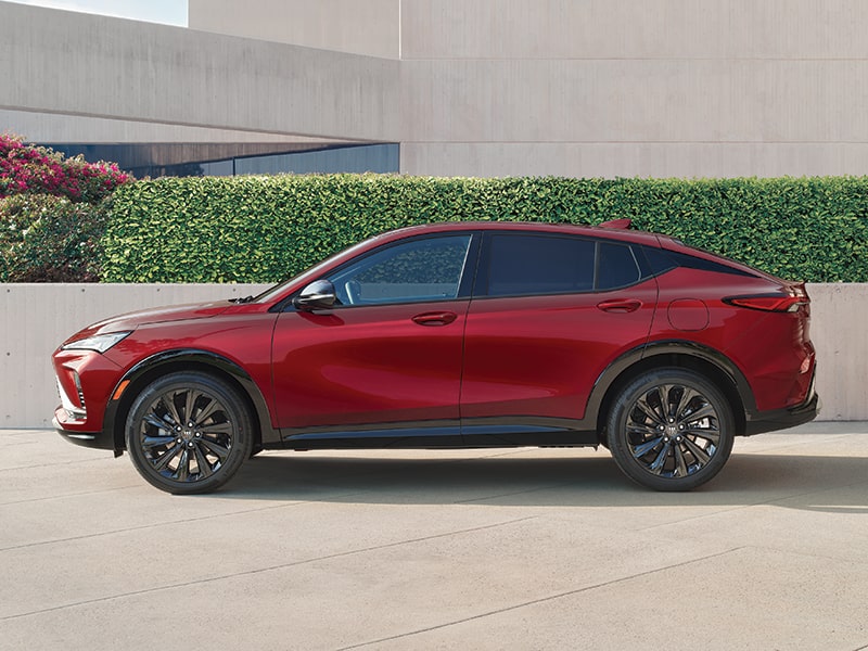 Exterior Side View of a Red Envista Sport Touring Parked in Front of a Building