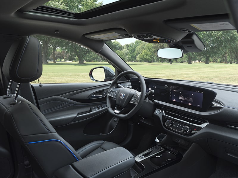 Three-Quarters View of the Envista Sport Touring SUV’s Driver Seat, Infotainment Screen and Steering Wheel