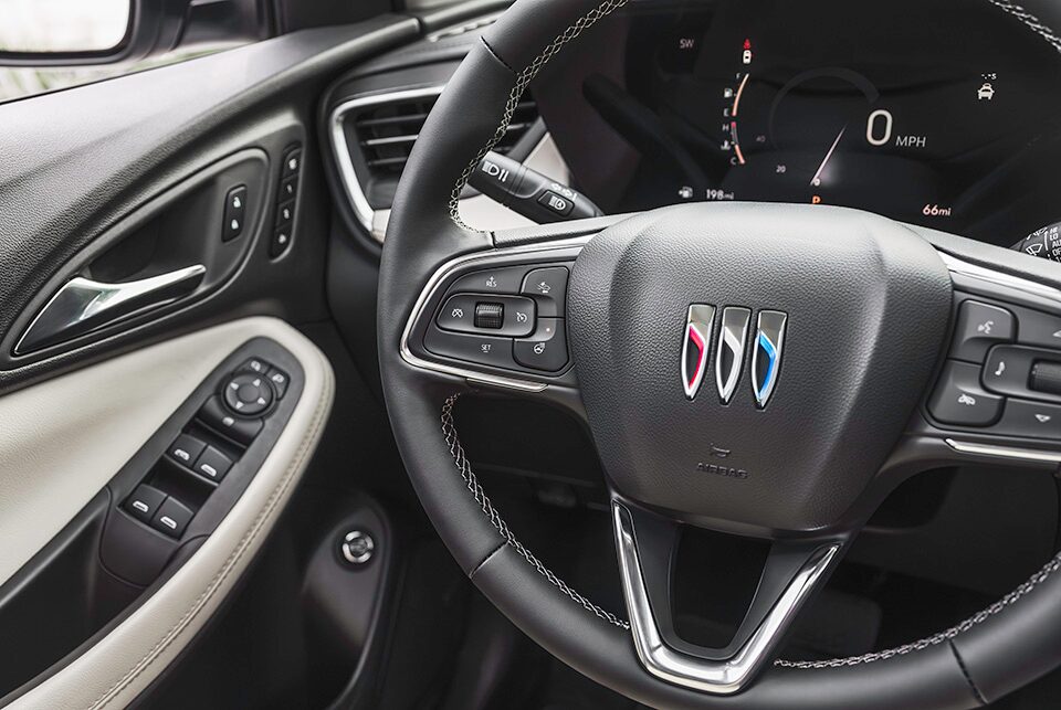 A Woman Sitting in a Buick Vehicle While Using an iPad To Display the MyBuick App