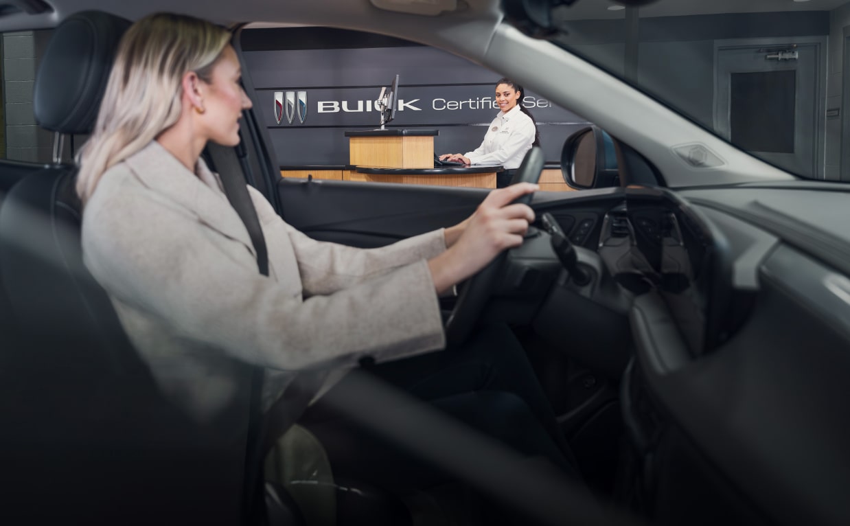 Women driving up to Buick service center in her Buick vehicle