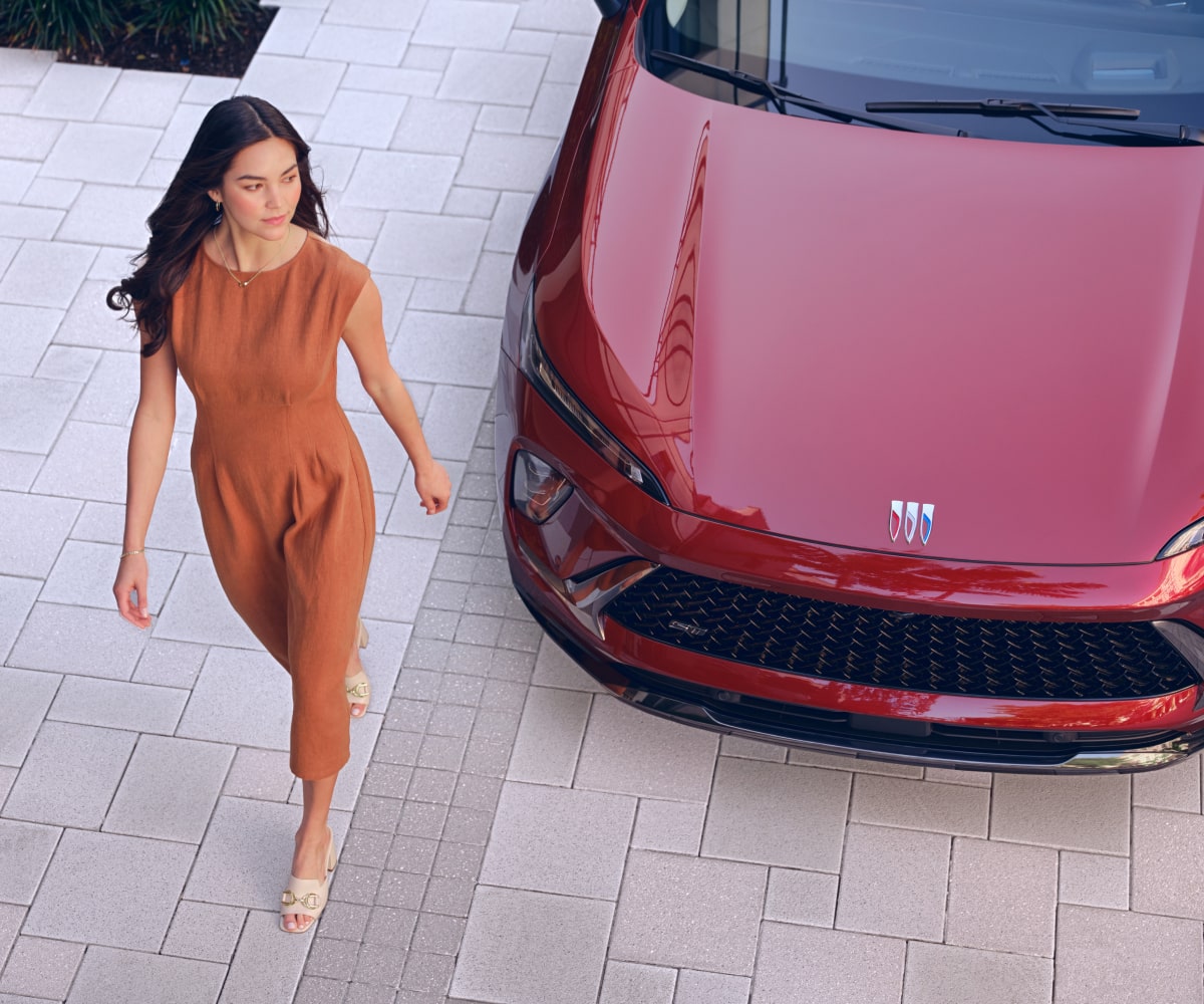 Couple walking up to their Buick vehicle