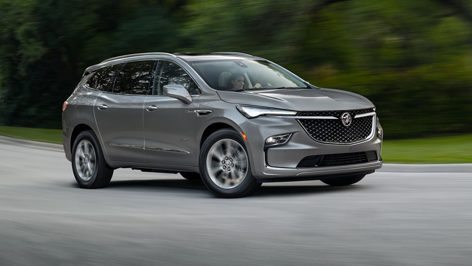 Buick SUV Driving on a Tree Lined Road