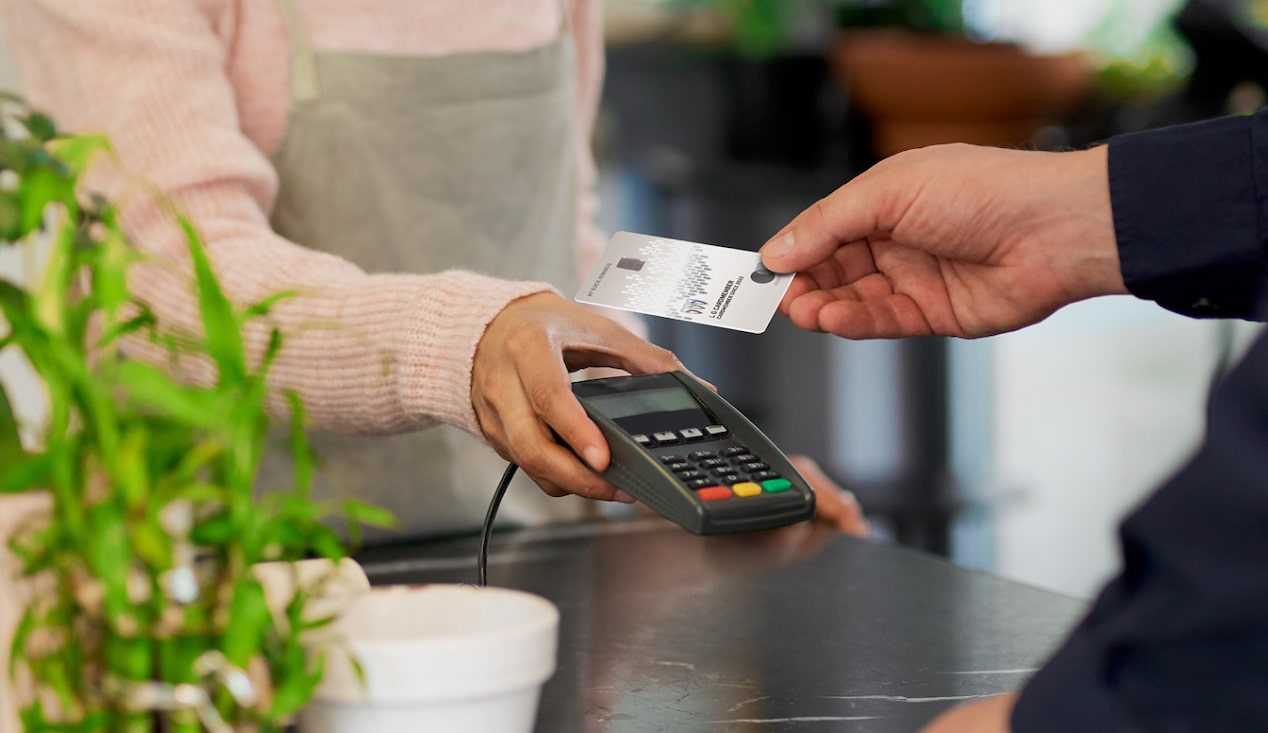 Man using his My Buick Rewards Card at coffee shop to earn points