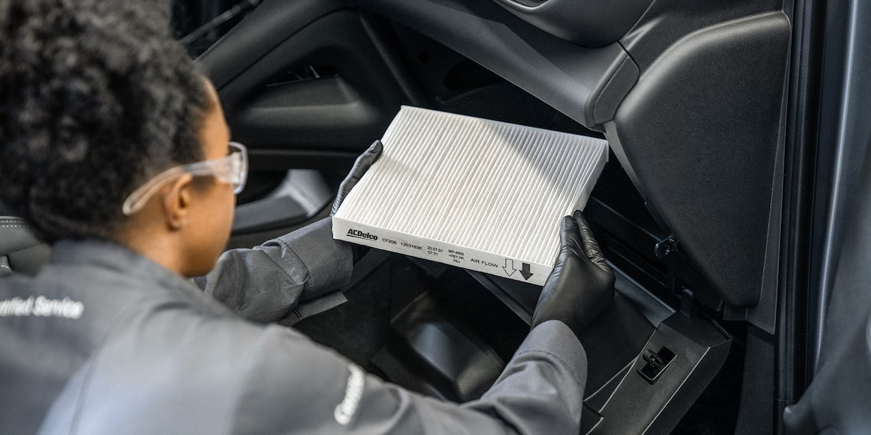 Buick Certified Service Technician Replacing Cabin Air Filter in a Vehicle