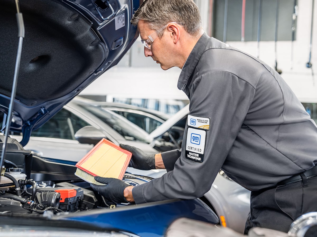 A Buick Certified Service Technician Changing an Air Filter