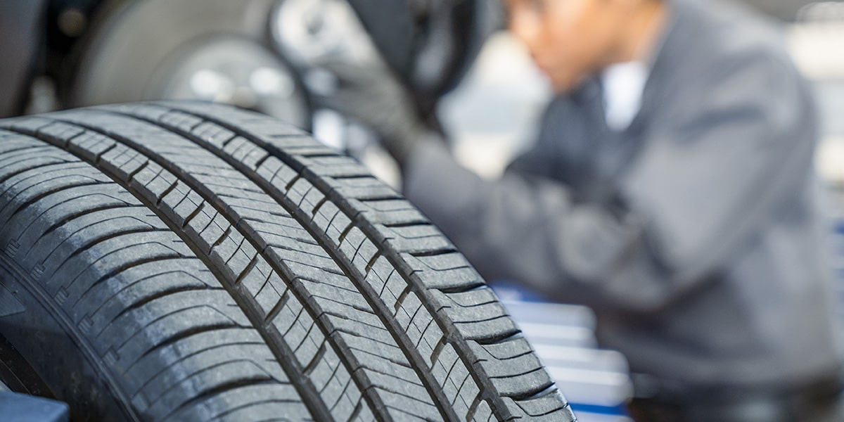 A Buick Certified Service Technician Working on a Buick Vehicle's Tires